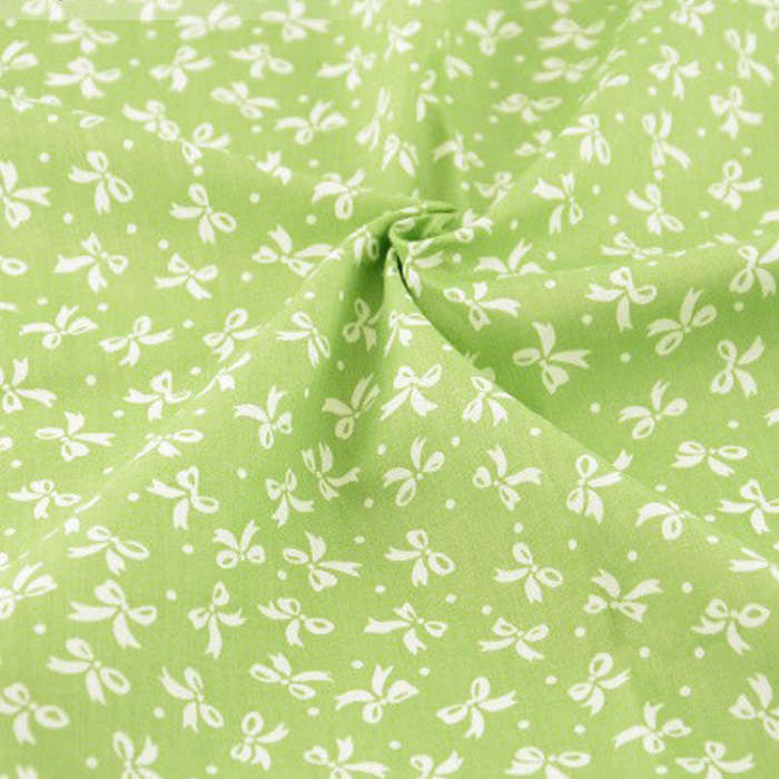 Ткань "Мелкие  бантики на зеленом фоне"    