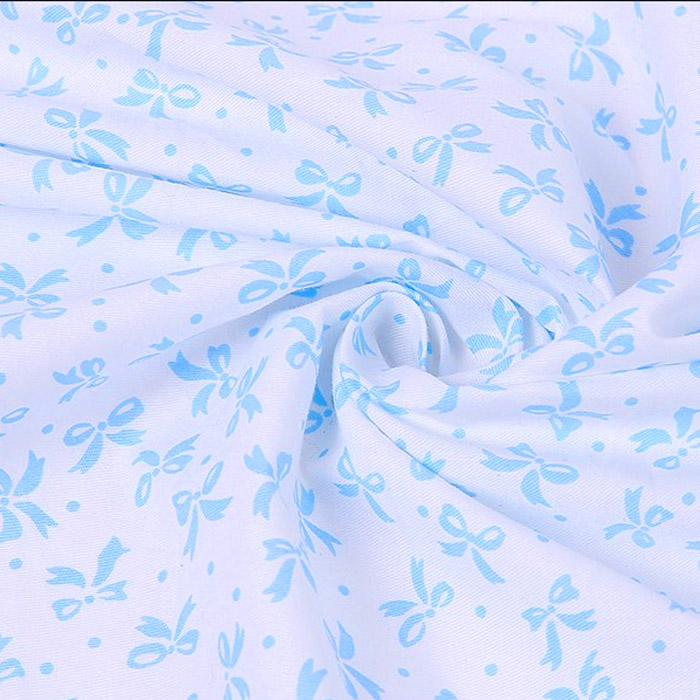 Ткань "Мелкие голубые бантики на белом фоне"   