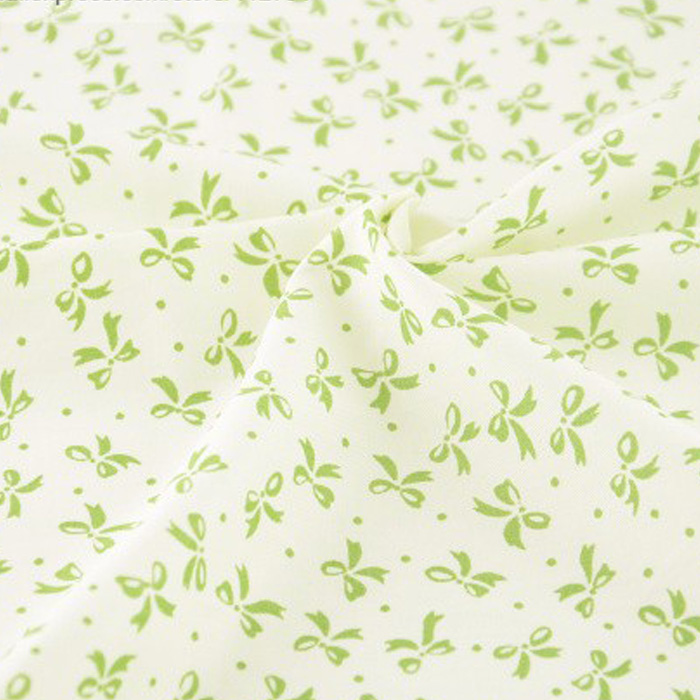 Ткань "Мелкие зеленые бантики на молочном фоне"    